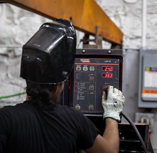 Man working with a machine at The Champion GSE