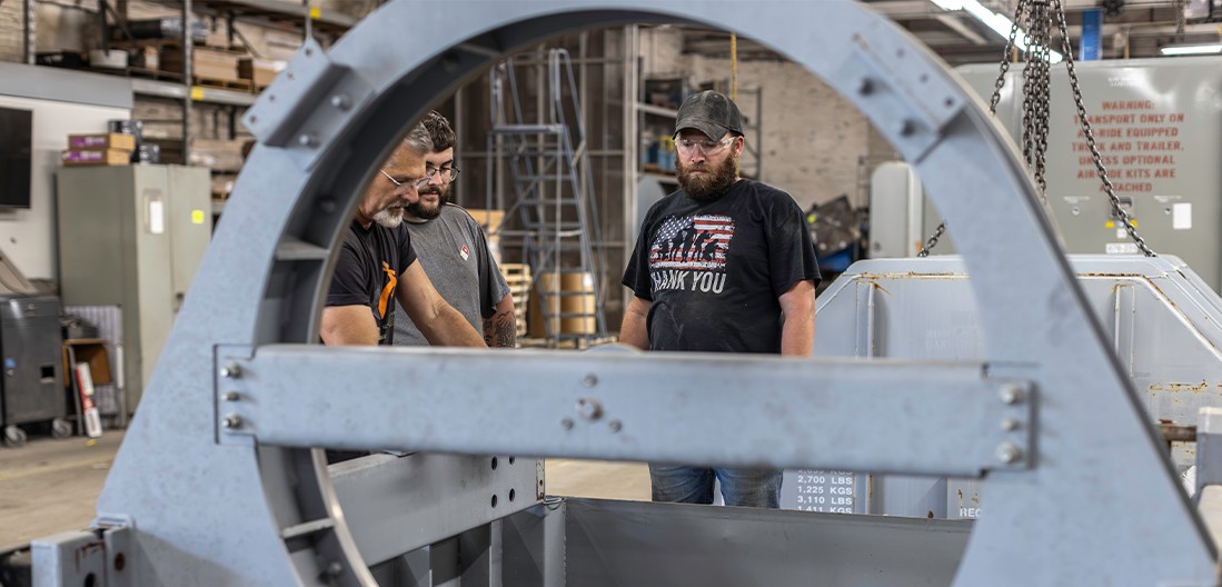 Men working on a container at the Champion GSE