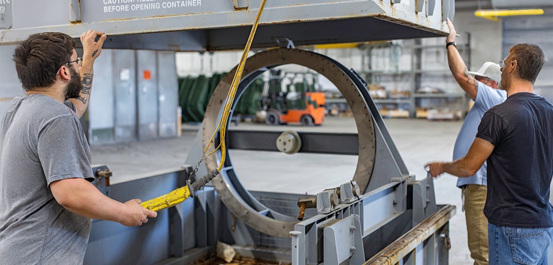 Workers putting a container together at The Champion GSE