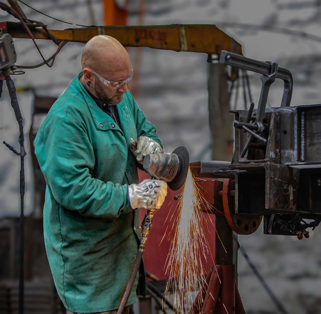Welder in action on a metal piece at Champion GSE